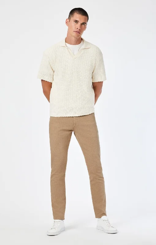 Men's Distressed Jeans with Patches for a Retro and DIY - Inspired AppearanceJAKE SLIM LEG IN NATURAL SAND DENIM